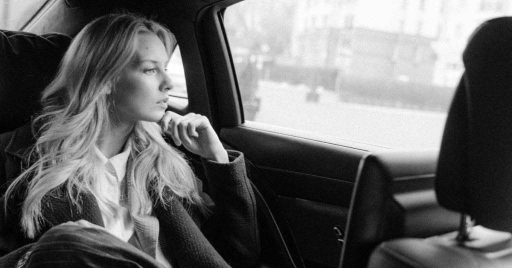 Woman looking out a car window